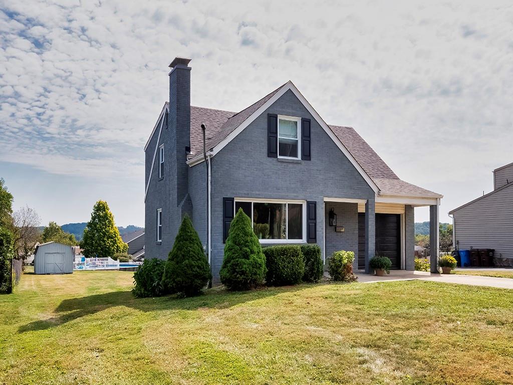 305 Prospect Circle Lower Burrell, PA 15068 - Photo 3 of 29 a front view of a house with a yard and palm trees