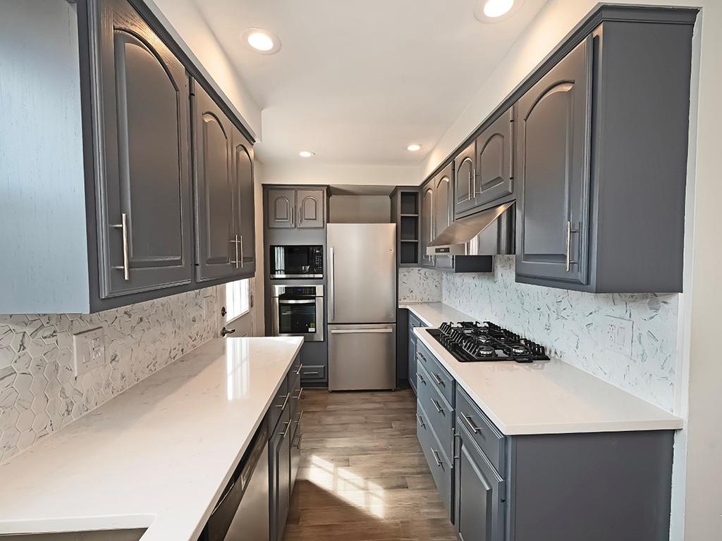 305 Prospect Circle Lower Burrell, PA 15068 - Photo 6 of 29 a kitchen with a refrigerator and a sink