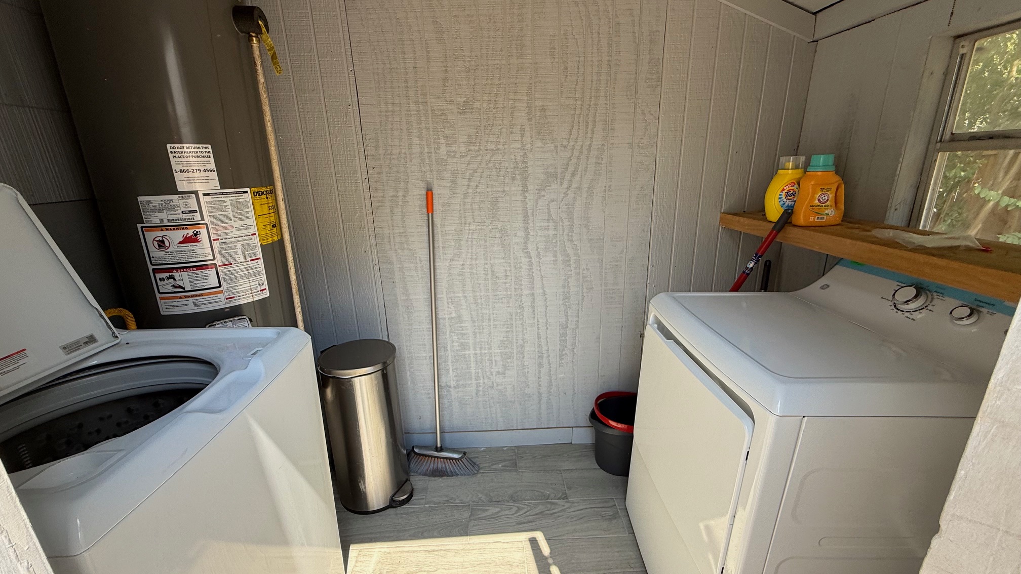 1802 East University Avenue, Unit A Georgetown, TX 78626 - Photo 16 of 23 Laundry area with washer / dryer, water heater, and wooden walls