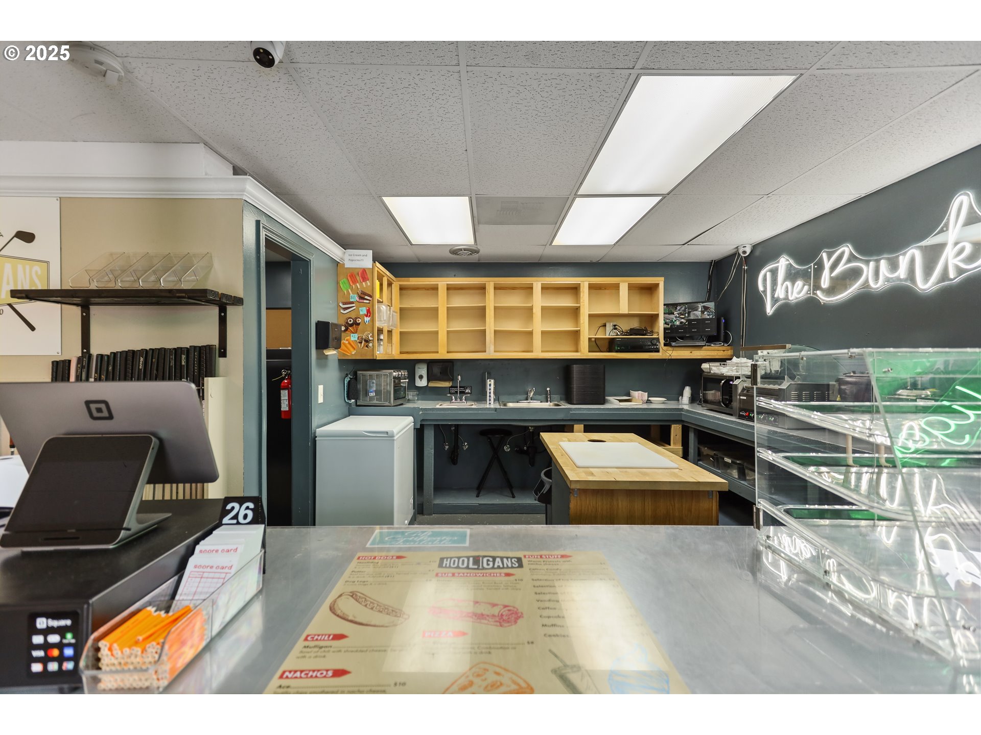 2718 East 2nd Street The Dalles, OR 97058 - Photo 33 of 45 a kitchen with stainless steel appliances kitchen island granite countertop a refrigerator and a wooden cabinets