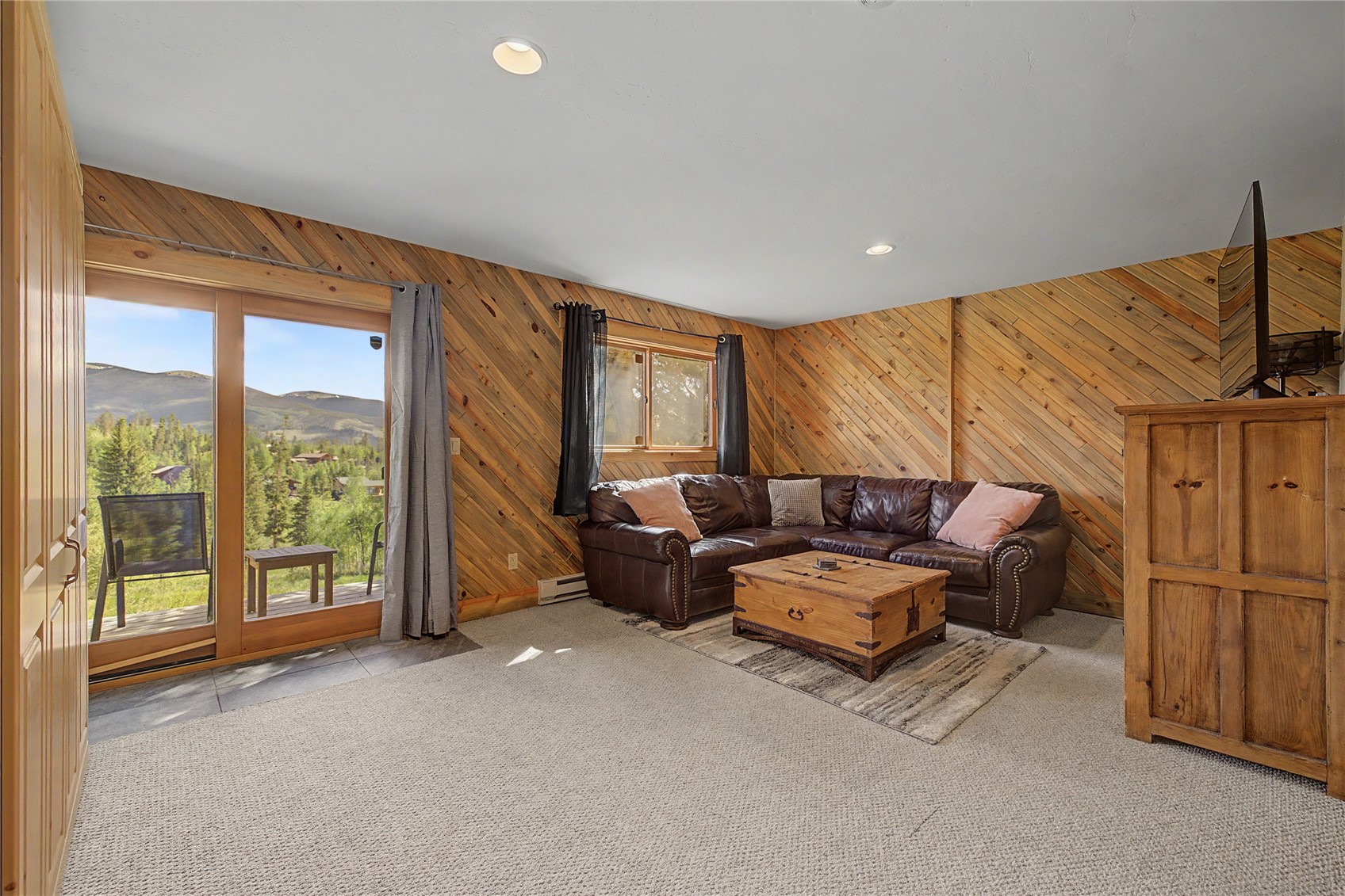 6726 Ryan Gulch Road, Unit 6726 Wildernest, CO 80498 - Photo 33 of 39 a living room with furniture and a floor to ceiling window