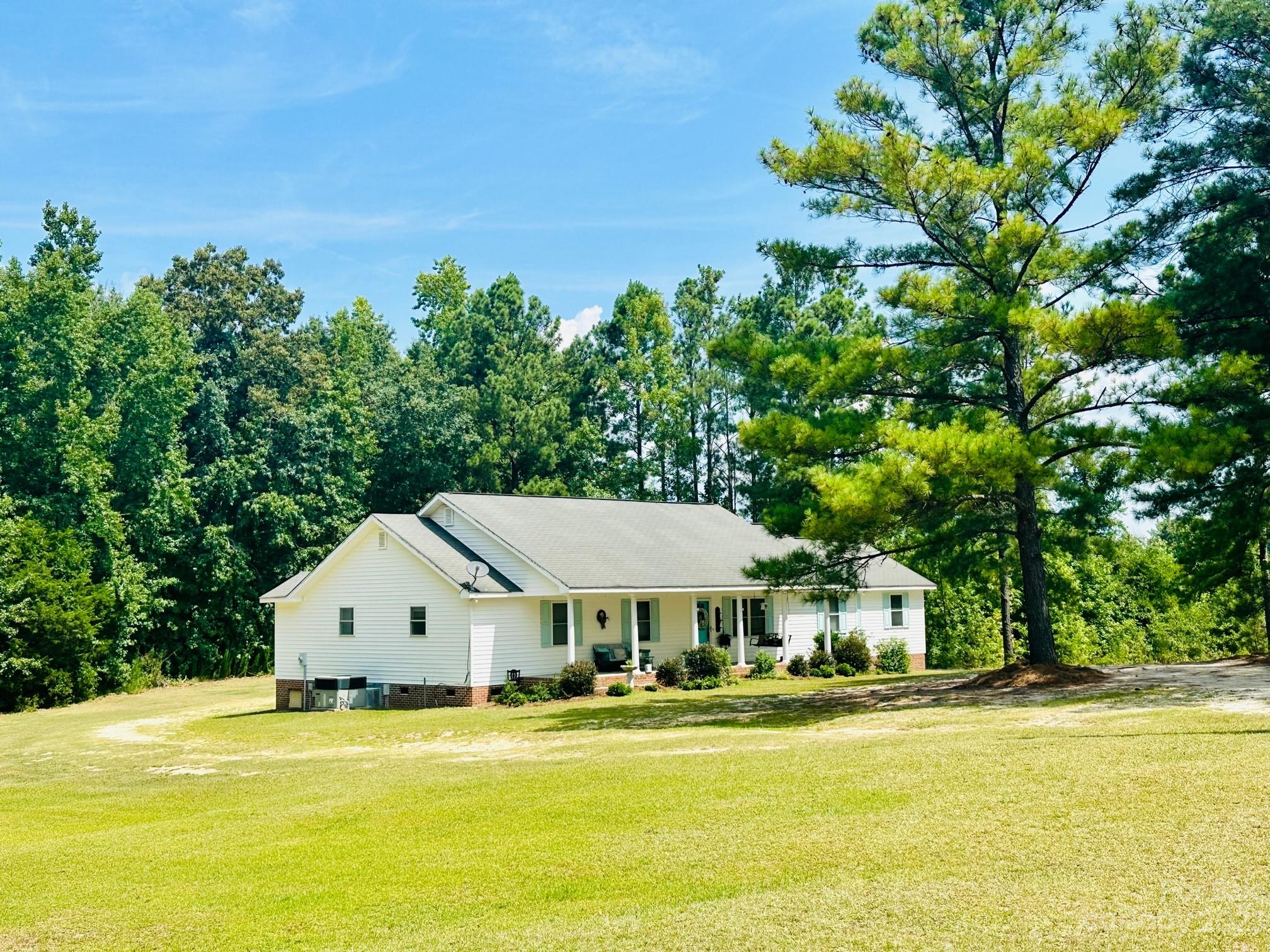 1880 Jones Road Kershaw, SC 29067 - Photo 1 of 33 a view of a house with a big yard and large trees