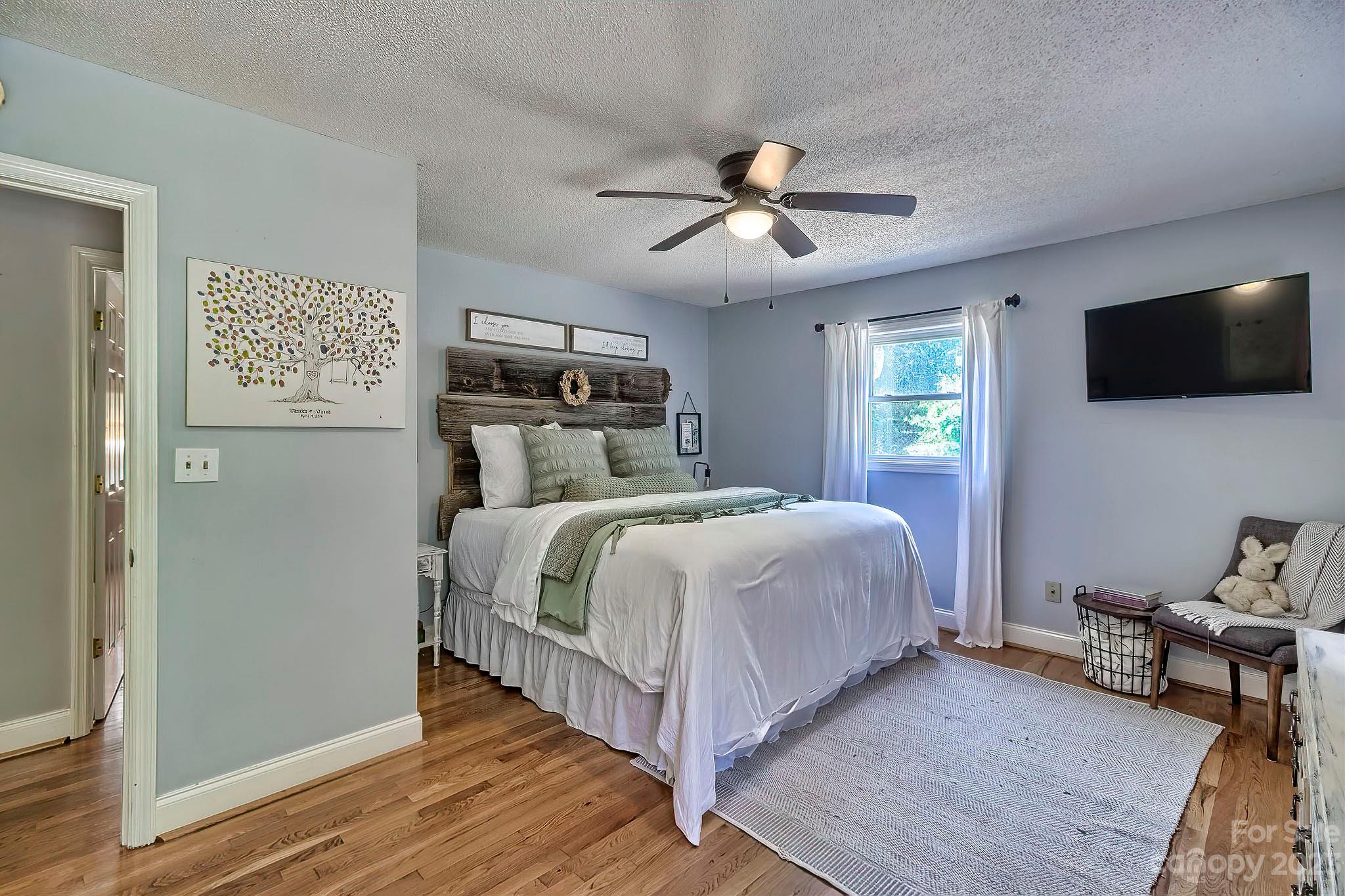 1880 Jones Road Kershaw, SC 29067 - Photo 13 of 33 a bedroom with a large bed a flat tv screen and a dresser