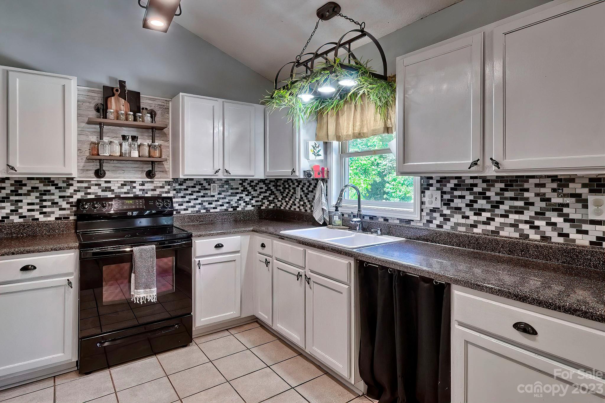 1880 Jones Road Kershaw, SC 29067 - Photo 28 of 33 a kitchen with a sink stove and cabinets