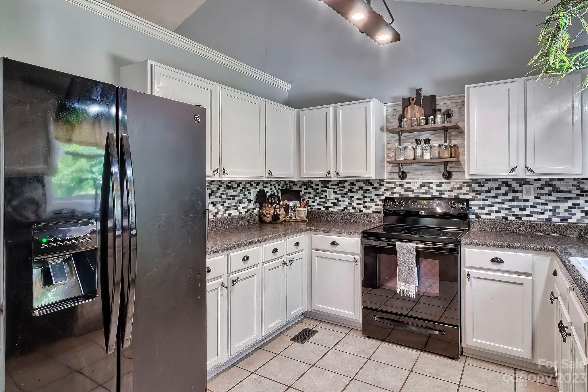 1880 Jones Road Kershaw, SC 29067 - Photo 30 of 33 a kitchen with stainless steel appliances granite countertop a stove a sink and a refrigerator