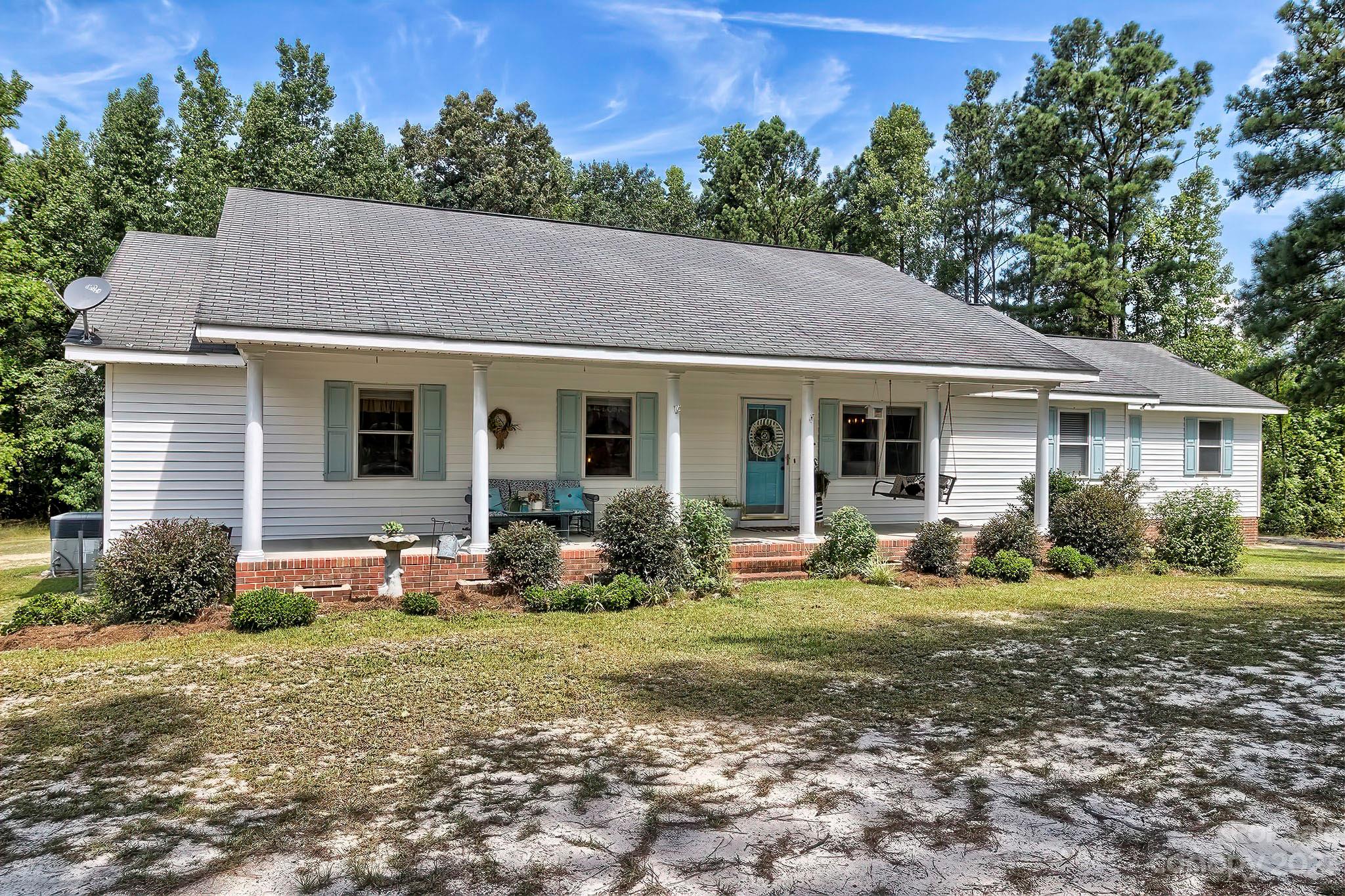 1880 Jones Road Kershaw, SC 29067 - Photo 3 of 33 a backyard of a house with yard table and chairs