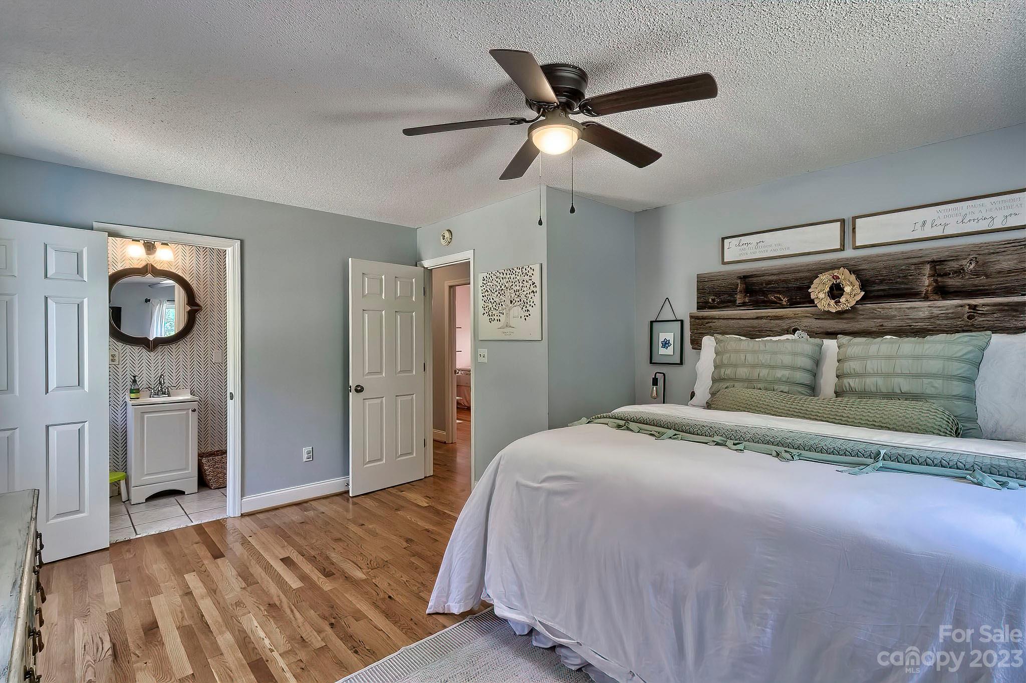 1880 Jones Road Kershaw, SC 29067 - Photo 8 of 33 a bedroom with a bed and a chandelier
