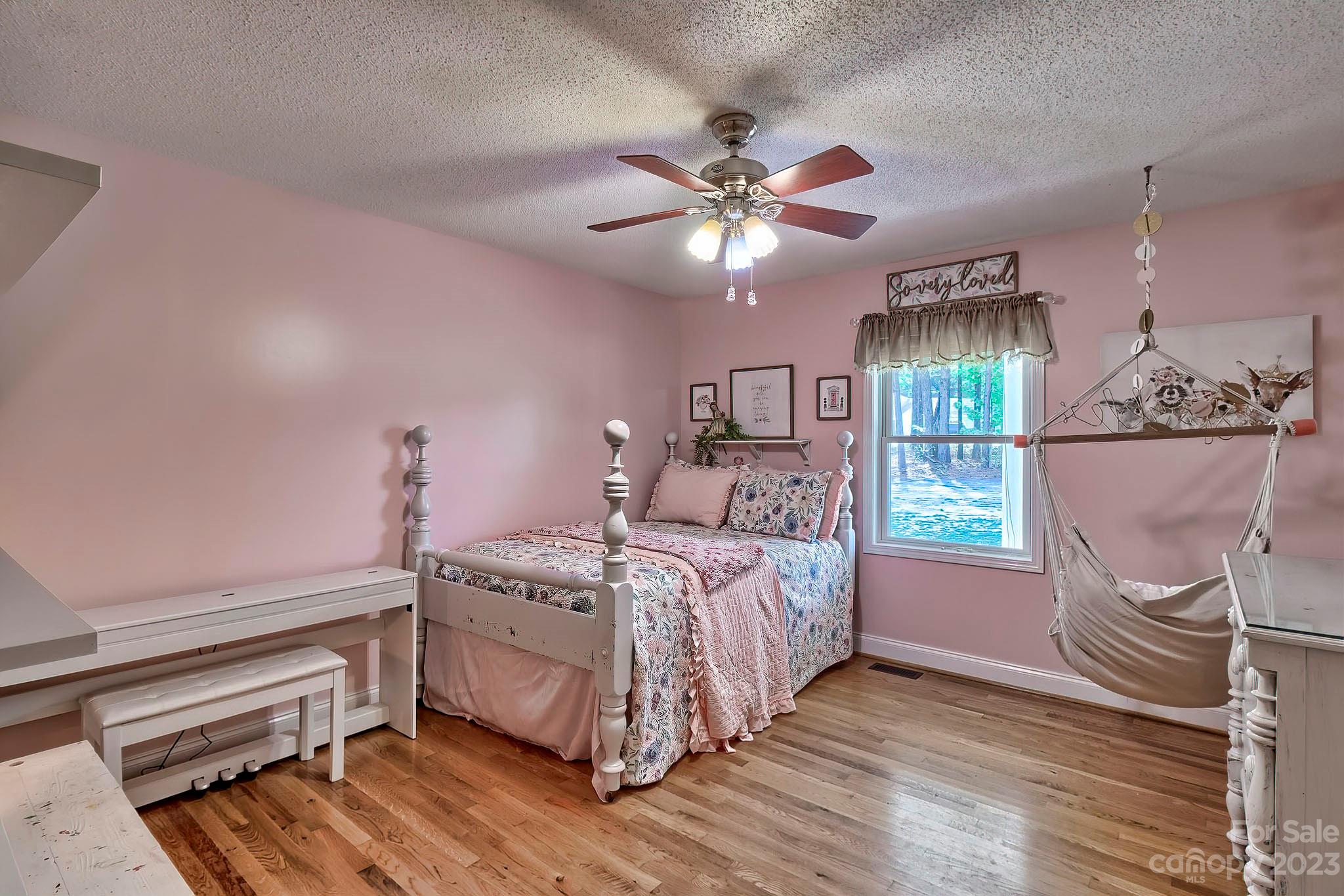 1880 Jones Road Kershaw, SC 29067 - Photo 9 of 33 a bedroom with a bed chandelier and a window