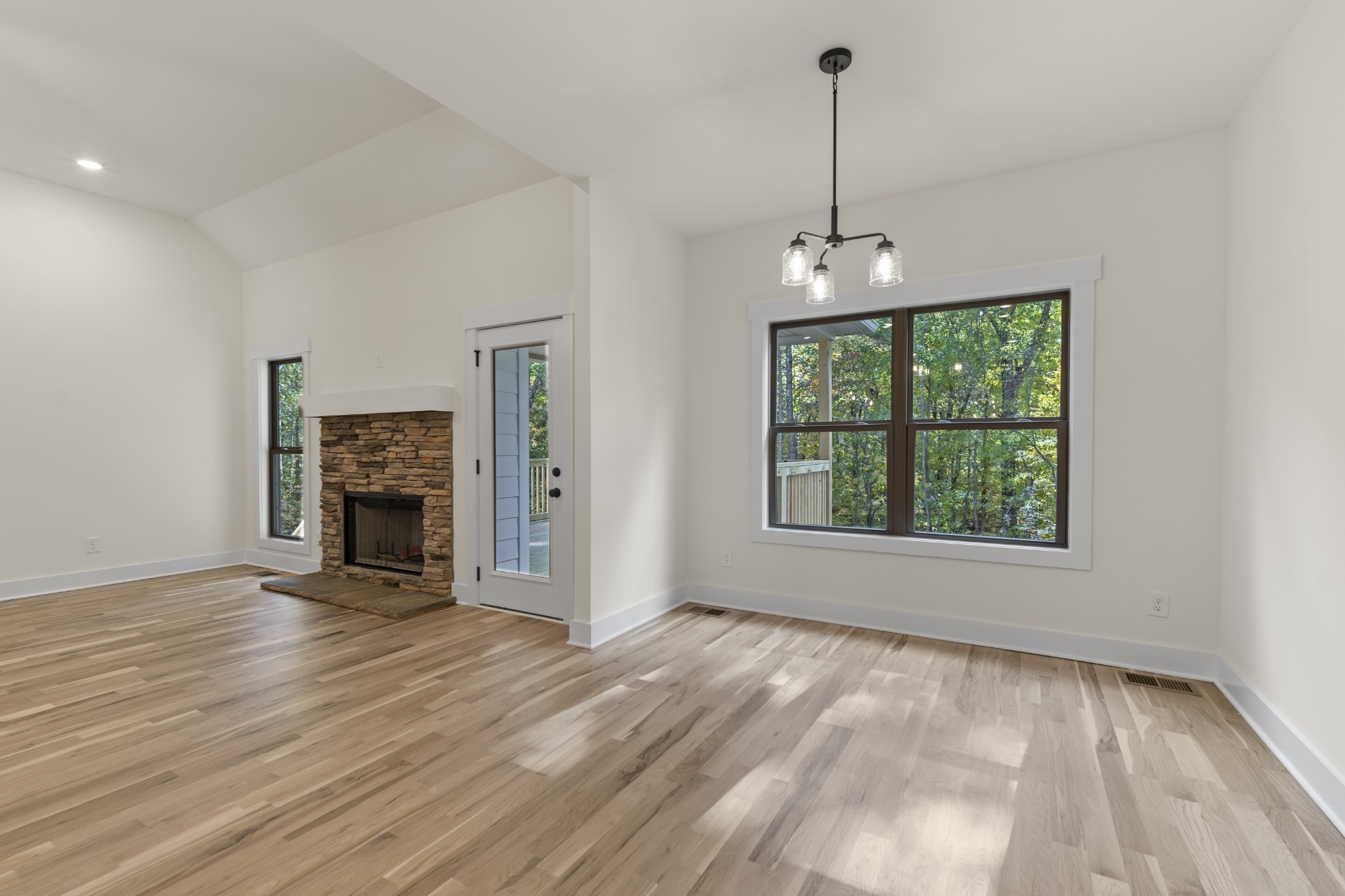 2969 Lights Chapel Road Greenbrier, TN 37073 - Photo 3 of 34 an empty room with fireplace windows and cabinet