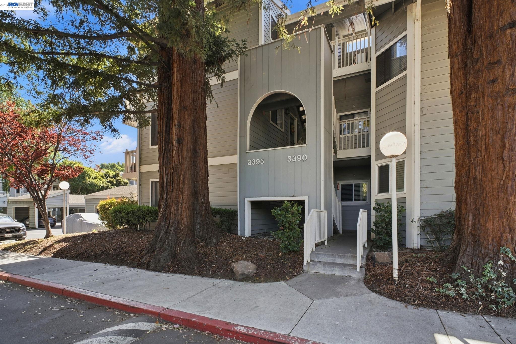3395 Pinewood Terrace, Unit 304 Fremont, CA 94536 - Photo 1 of 33 a front view of a house with plants