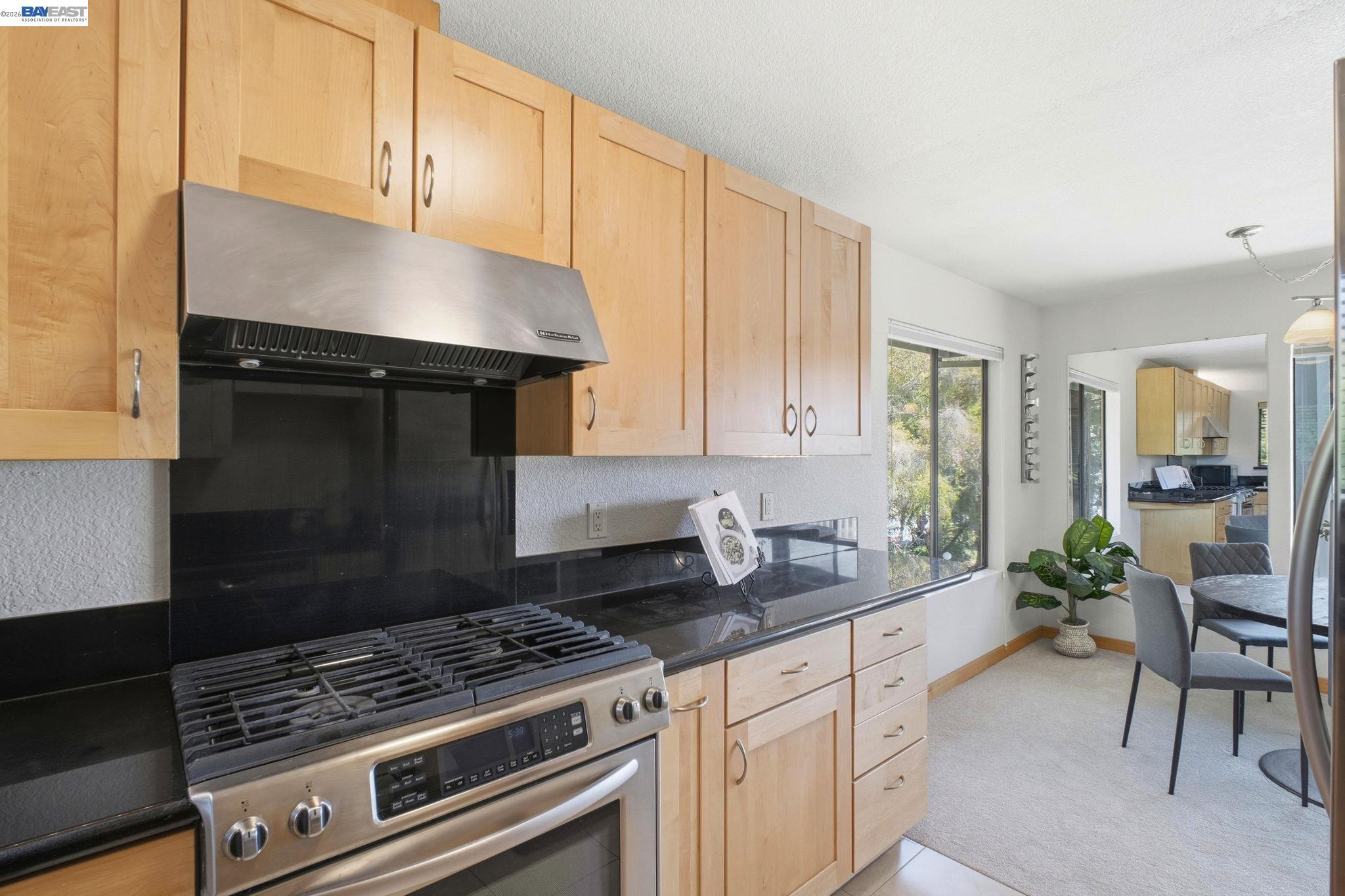 3395 Pinewood Terrace, Unit 304 Fremont, CA 94536 - Photo 11 of 33 a kitchen with granite countertop a stove a sink and a cabinets