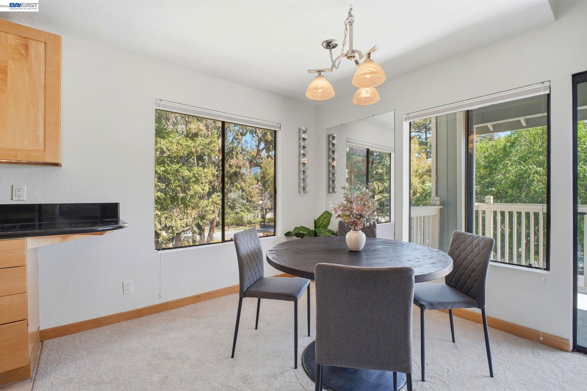 3395 Pinewood Terrace, Unit 304 Fremont, CA 94536 - Photo 15 of 33 a dining room with furniture a large window and wooden floor