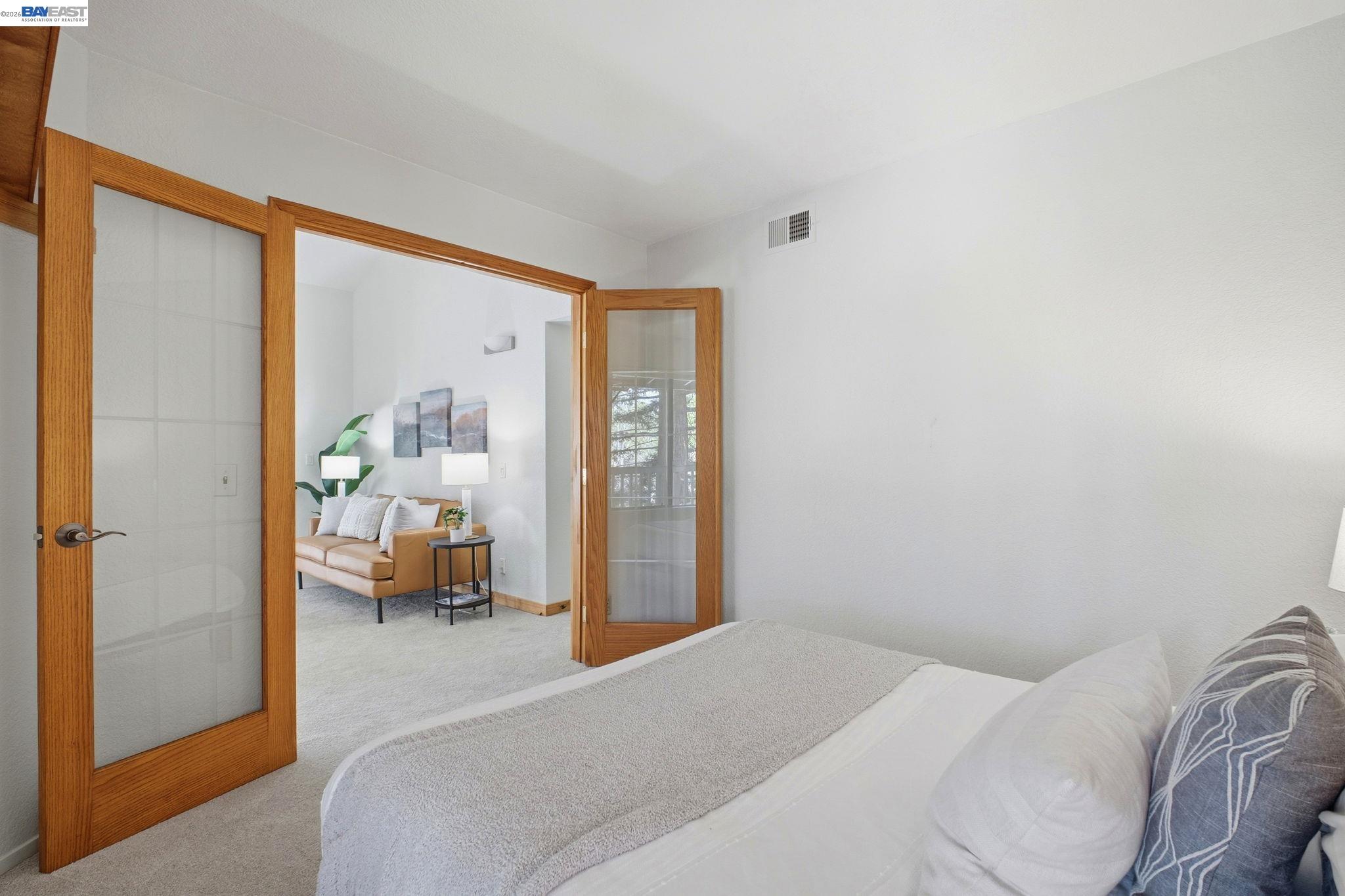 3395 Pinewood Terrace, Unit 304 Fremont, CA 94536 - Photo 17 of 33 a bedroom with a bed and wooden floor
