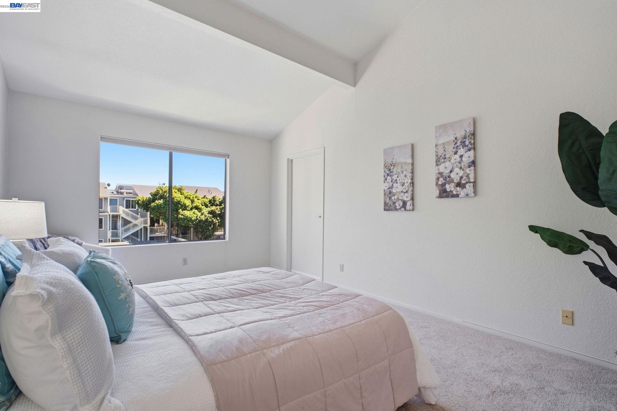3395 Pinewood Terrace, Unit 304 Fremont, CA 94536 - Photo 19 of 33 a bedroom with a bed and a potted plant