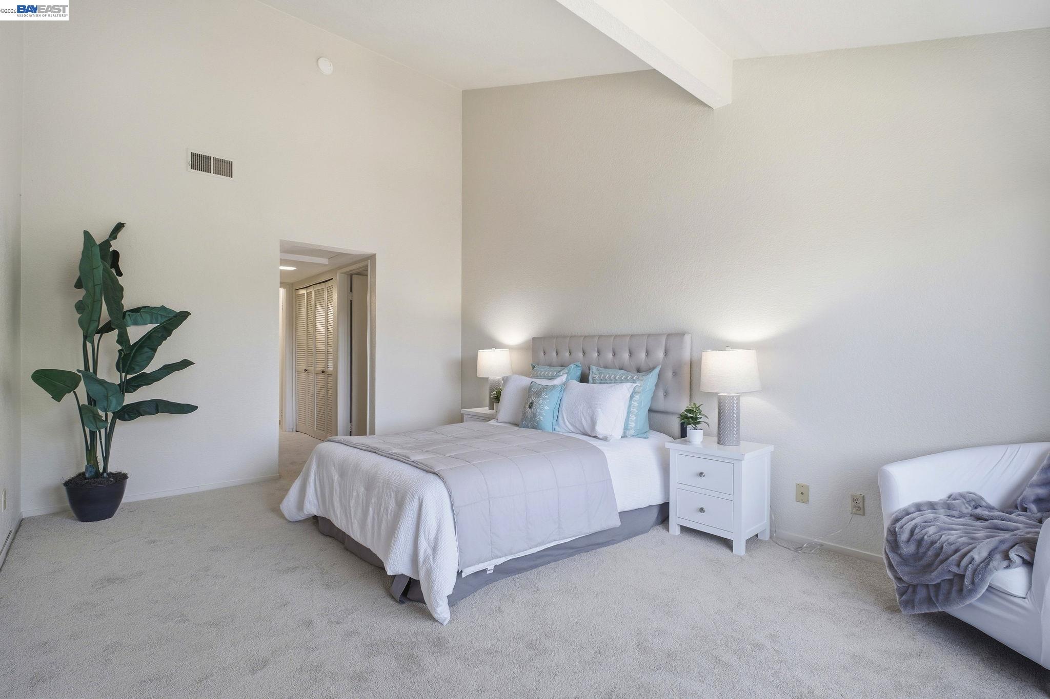 3395 Pinewood Terrace, Unit 304 Fremont, CA 94536 - Photo 20 of 33 a bedroom with a bed and a potted plant