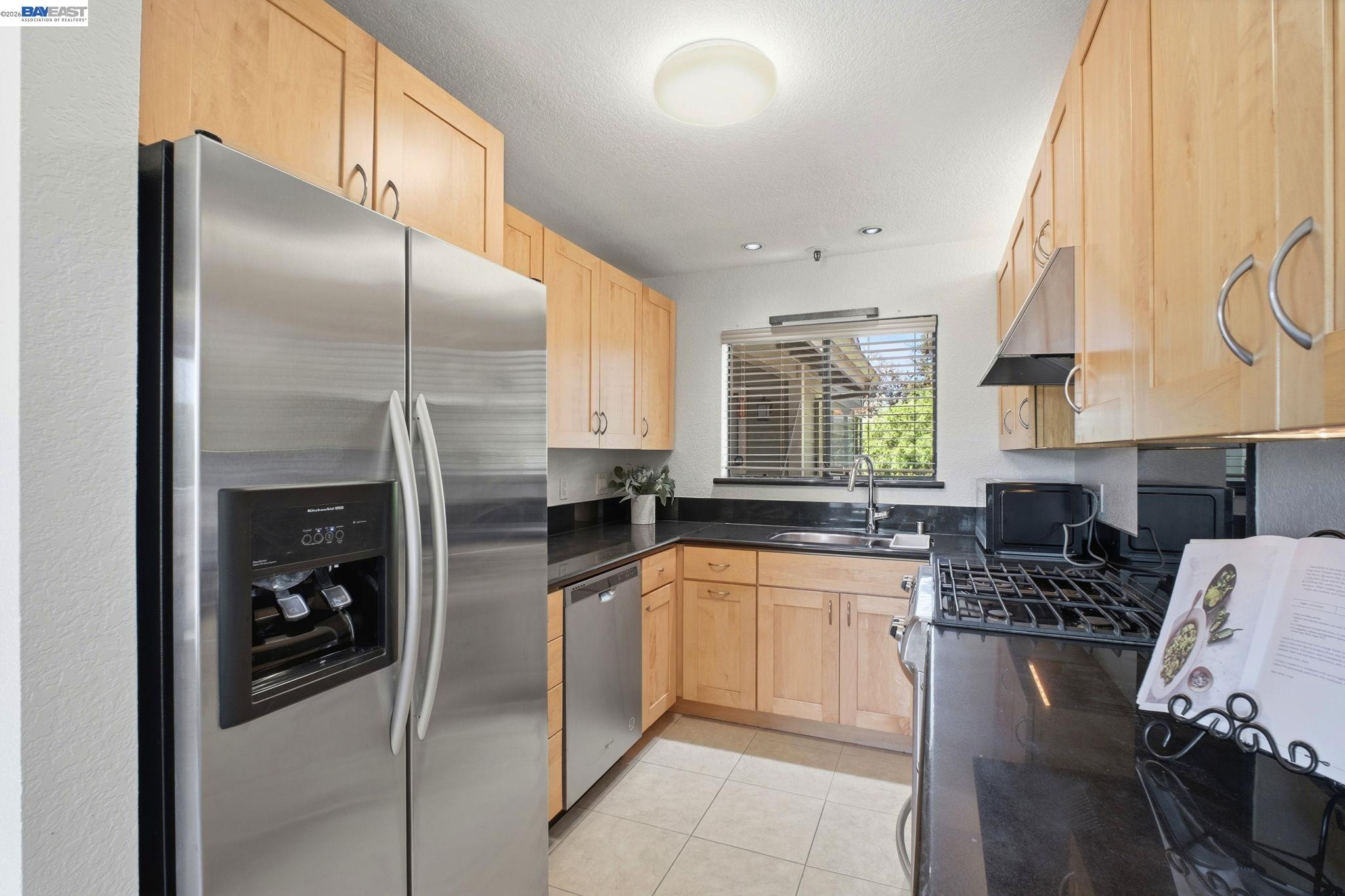 3395 Pinewood Terrace, Unit 304 Fremont, CA 94536 - Photo 9 of 33 a kitchen with stainless steel appliances granite countertop a sink a stove and a refrigerator