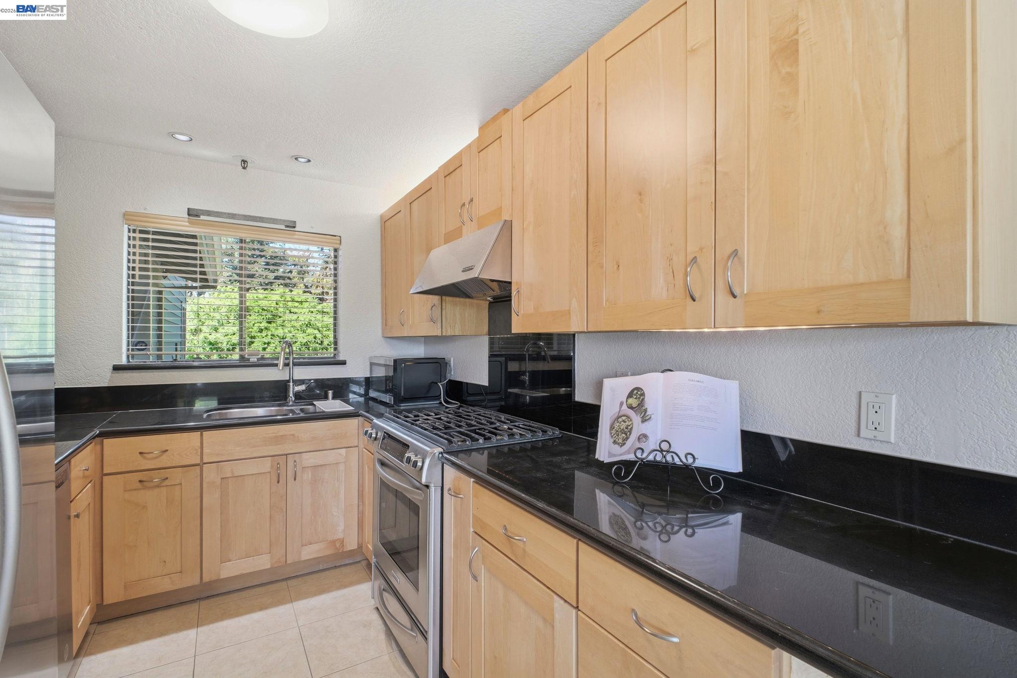 3395 Pinewood Terrace, Unit 304 Fremont, CA 94536 - Photo 10 of 33 a kitchen with white cabinets and sink