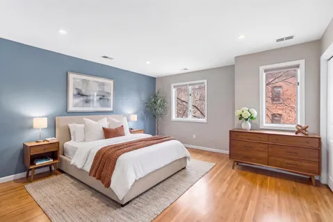 a bedroom with a bed furniture and a book shelf