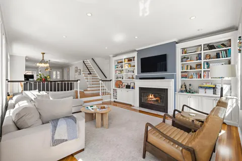 a living room with furniture a flat screen tv and a fireplace