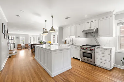 a kitchen with stainless steel appliances granite countertop a stove oven and a refrigerator
