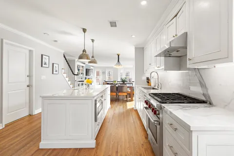 a kitchen with stainless steel appliances granite countertop a stove and a sink