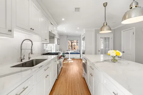 a kitchen with counter top space a sink appliances and cabinets
