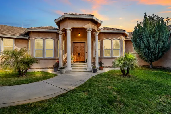 a front view of a house with garden
