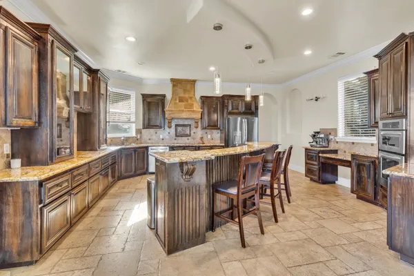 a open kitchen with stainless steel appliances granite countertop a stove and a sink