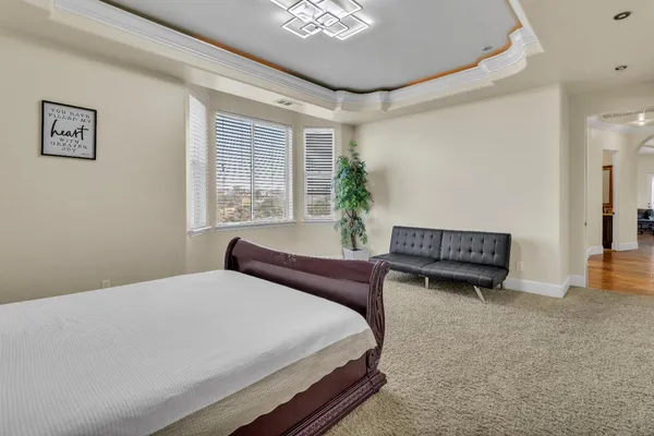 a bedroom with a bed and a chair