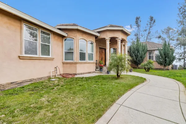 a front view of a house with a yard