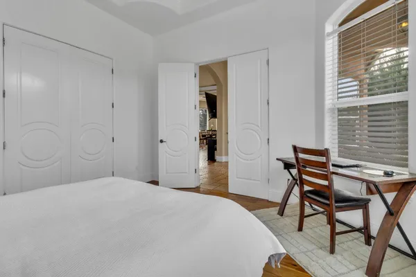 a bedroom with a large bed and a window