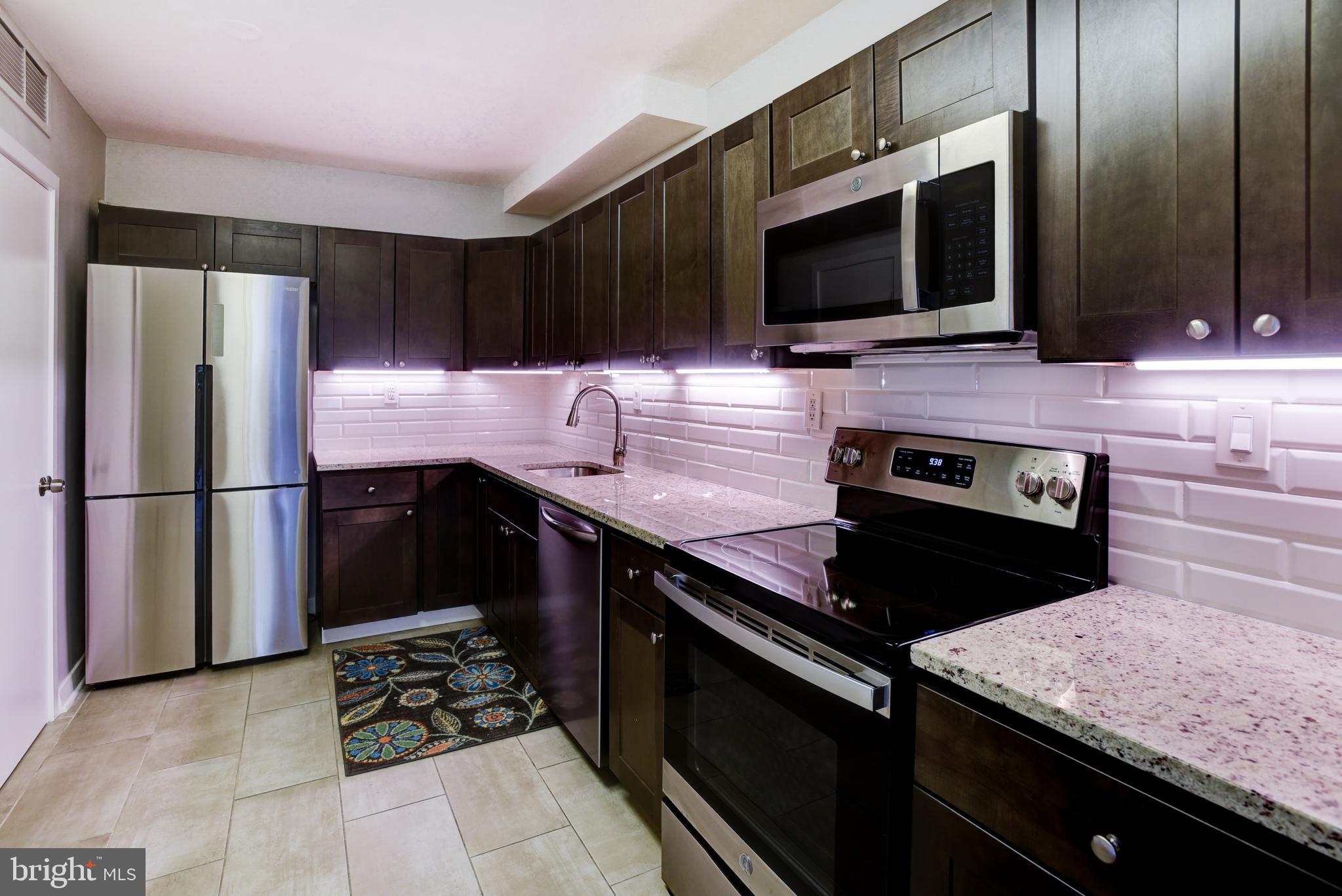 4100 Cathedral Avenue Northwest, Unit 512 Washington, DC 20016 - Photo 19 of 71 a kitchen with a sink appliances and cabinets