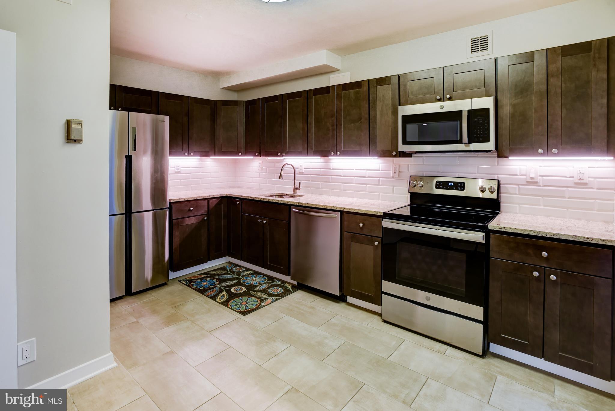4100 Cathedral Avenue Northwest, Unit 512 Washington, DC 20016 - Photo 20 of 71 a kitchen with a sink stove and refrigerator