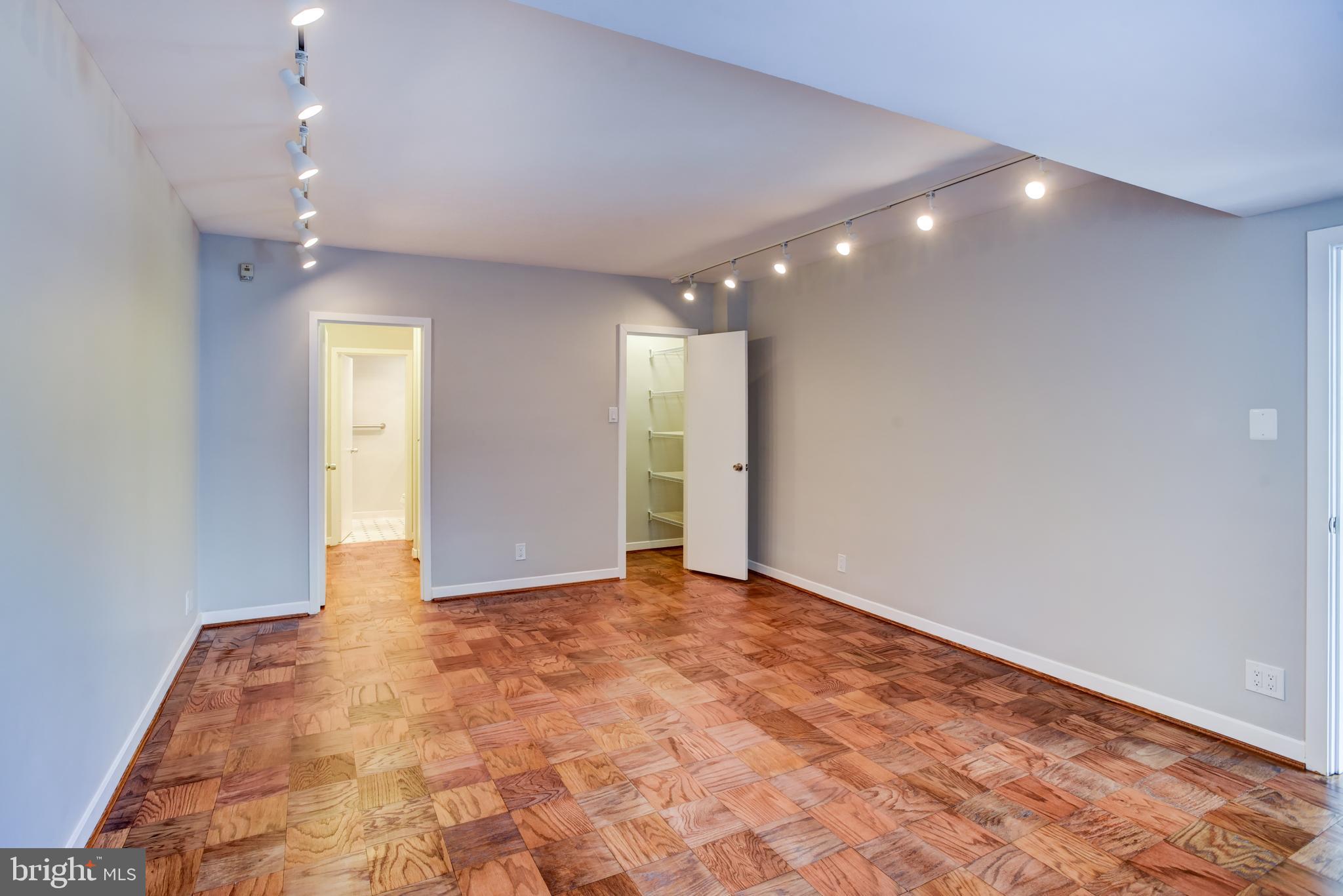 4100 Cathedral Avenue Northwest, Unit 512 Washington, DC 20016 - Photo 33 of 71 an empty room with closet and wooden floor