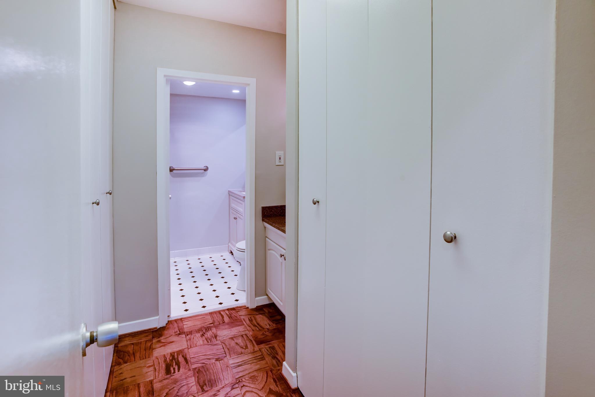 4100 Cathedral Avenue Northwest, Unit 512 Washington, DC 20016 - Photo 37 of 71 a bedroom with a bed and a bathroom