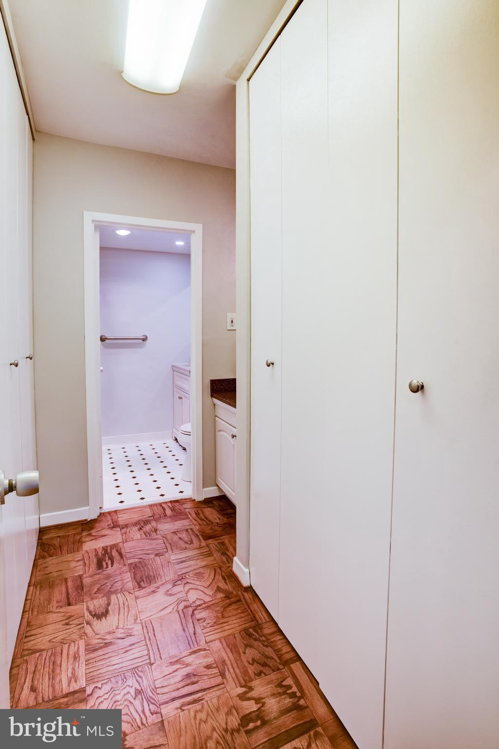 4100 Cathedral Avenue Northwest, Unit 512 Washington, DC 20016 - Photo 38 of 71 a bedroom with a bed and a mirror