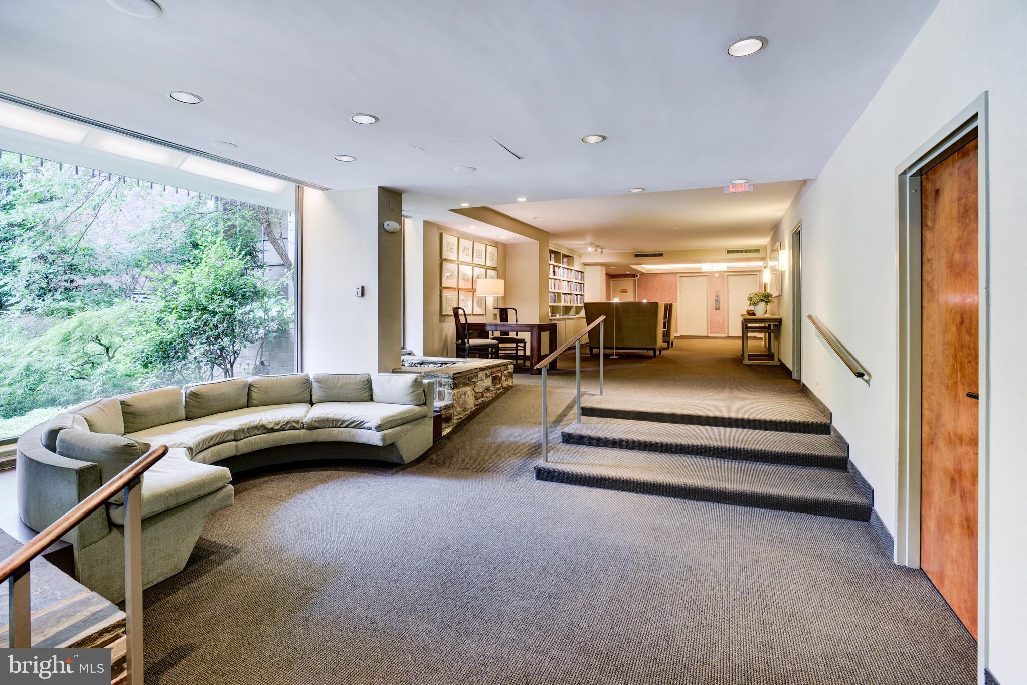 4100 Cathedral Avenue Northwest, Unit 512 Washington, DC 20016 - Photo 5 of 71 a living room with furniture gym equipment and large windows