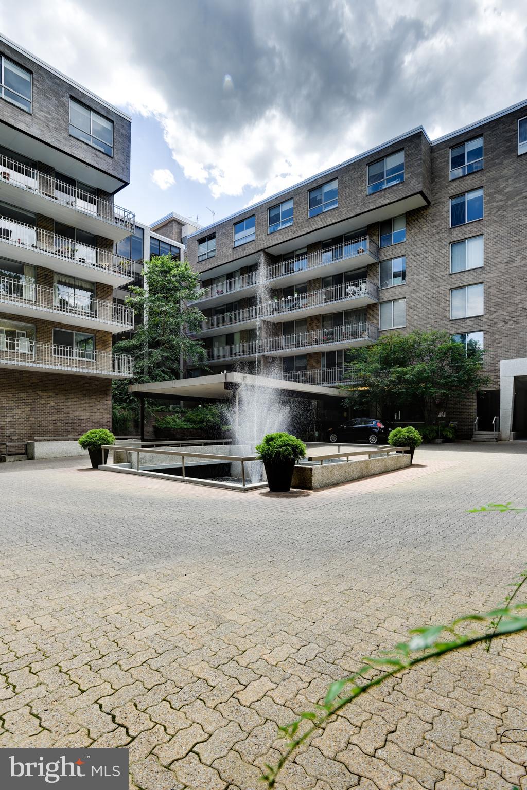 4100 Cathedral Avenue Northwest, Unit 512 Washington, DC 20016 - Photo 51 of 71 a front view of a house with a yard and a garage
