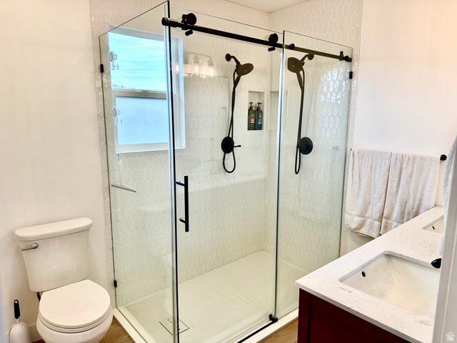 7818 North Windhover Road Eagle Mountain, UT 84005 - Photo 15 of 32 Frameless glass shower enclosure featuring dual matte black shower heads and a built-in niche