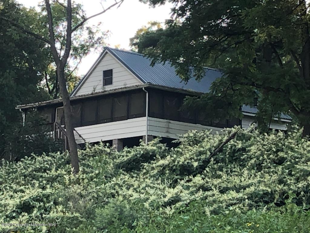 738 Myo Beach Road Meshoppen, PA 18630 - Photo 1 of 14 a backyard of a house with plants and trees