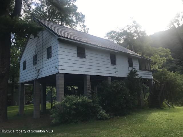 738 Myo Beach Road Meshoppen, PA 18630 - Photo 2 of 14 a front view of a house with garden