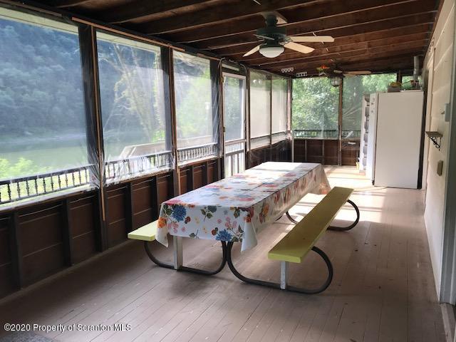 738 Myo Beach Road Meshoppen, PA 18630 - Photo 5 of 14 a bedroom with a bed and large window