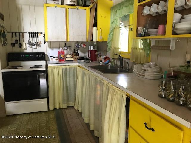 738 Myo Beach Road Meshoppen, PA 18630 - Photo 10 of 14 a kitchen with sink a stove and cabinets
