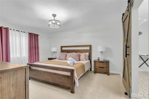 a bedroom with a bed and a chandelier