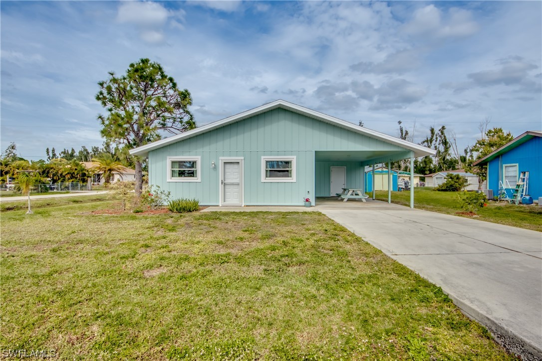5892 Sailfish Road Bokeelia, FL 33922 - Photo 1 of 32 a front view of a house with garden