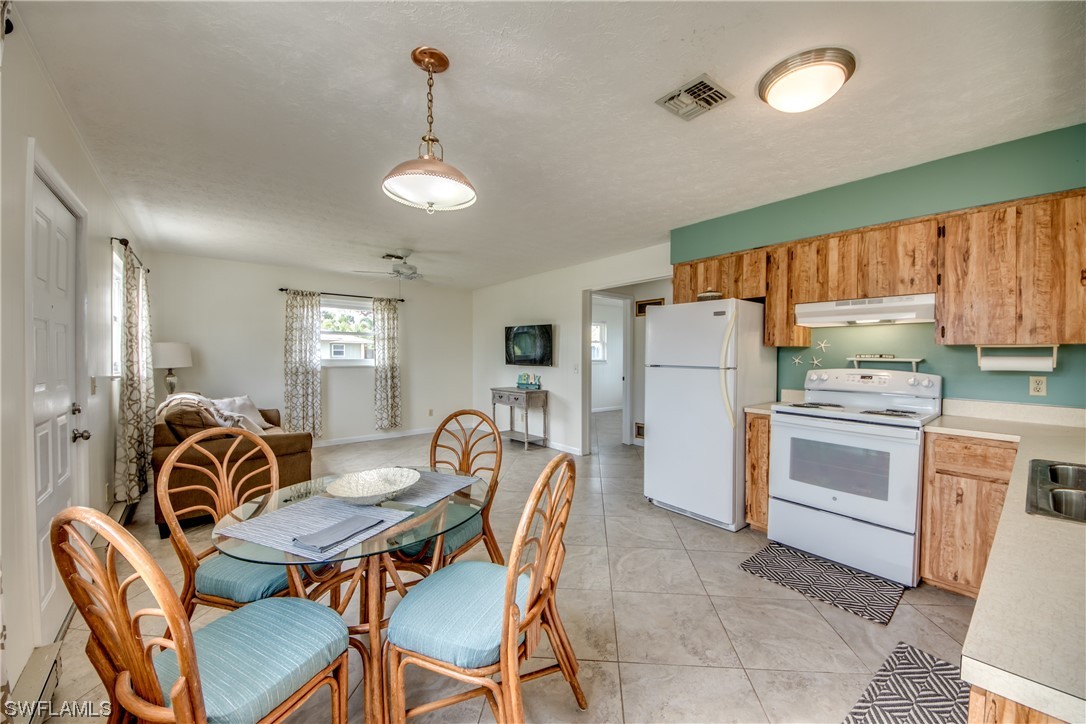 5892 Sailfish Road Bokeelia, FL 33922 - Photo 12 of 32 a view of kitchen with cabinets and wooden floor