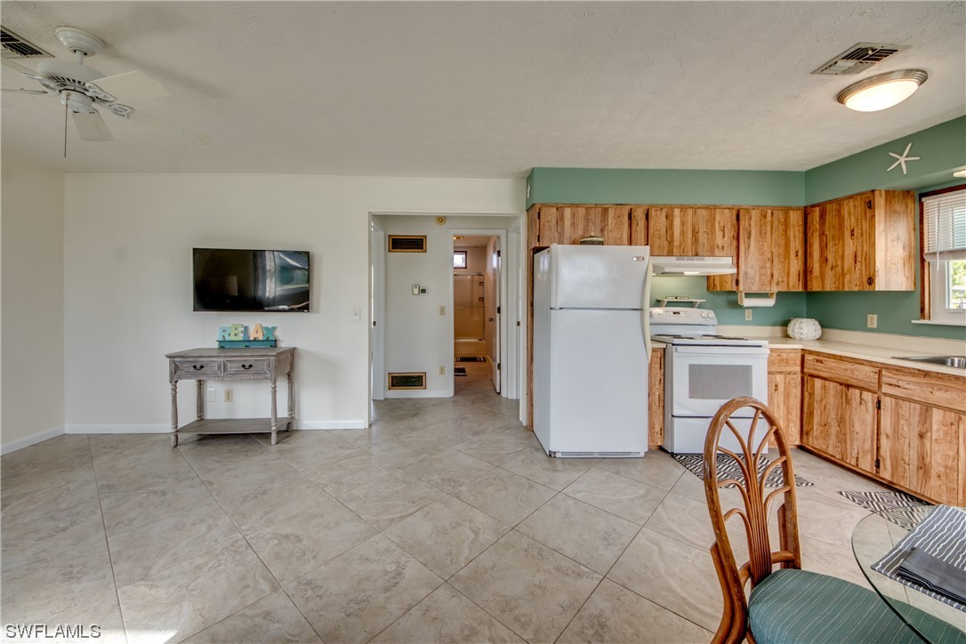 5892 Sailfish Road Bokeelia, FL 33922 - Photo 13 of 32 a kitchen with refrigerator and window