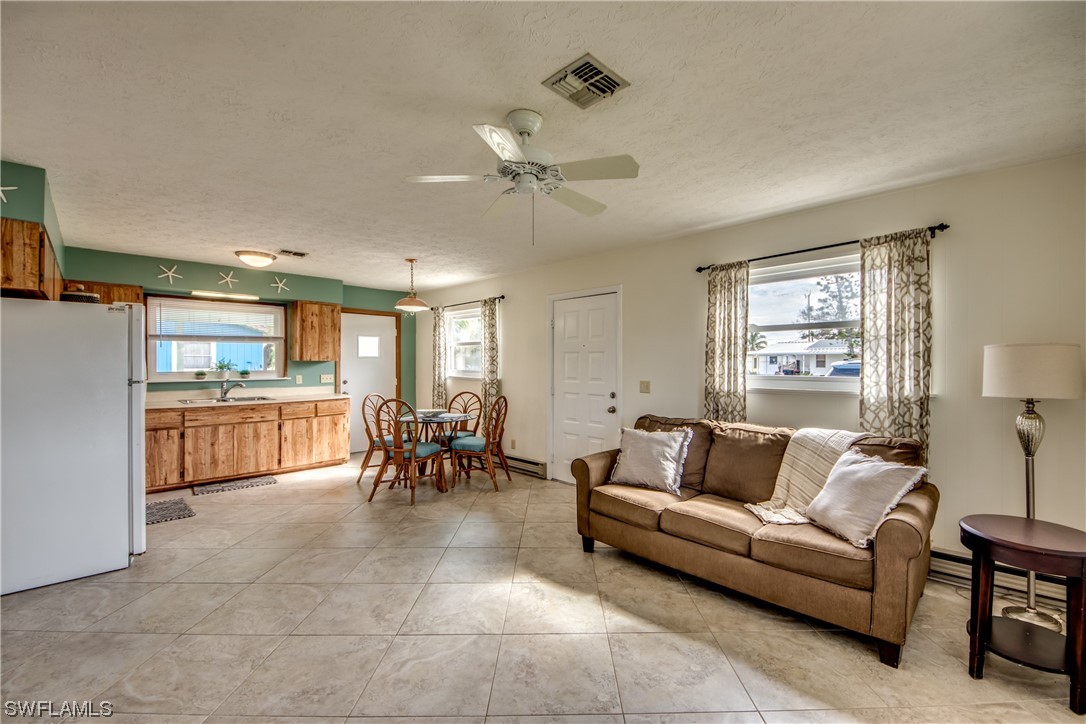 5892 Sailfish Road Bokeelia, FL 33922 - Photo 15 of 32 a living room with furniture and a large window