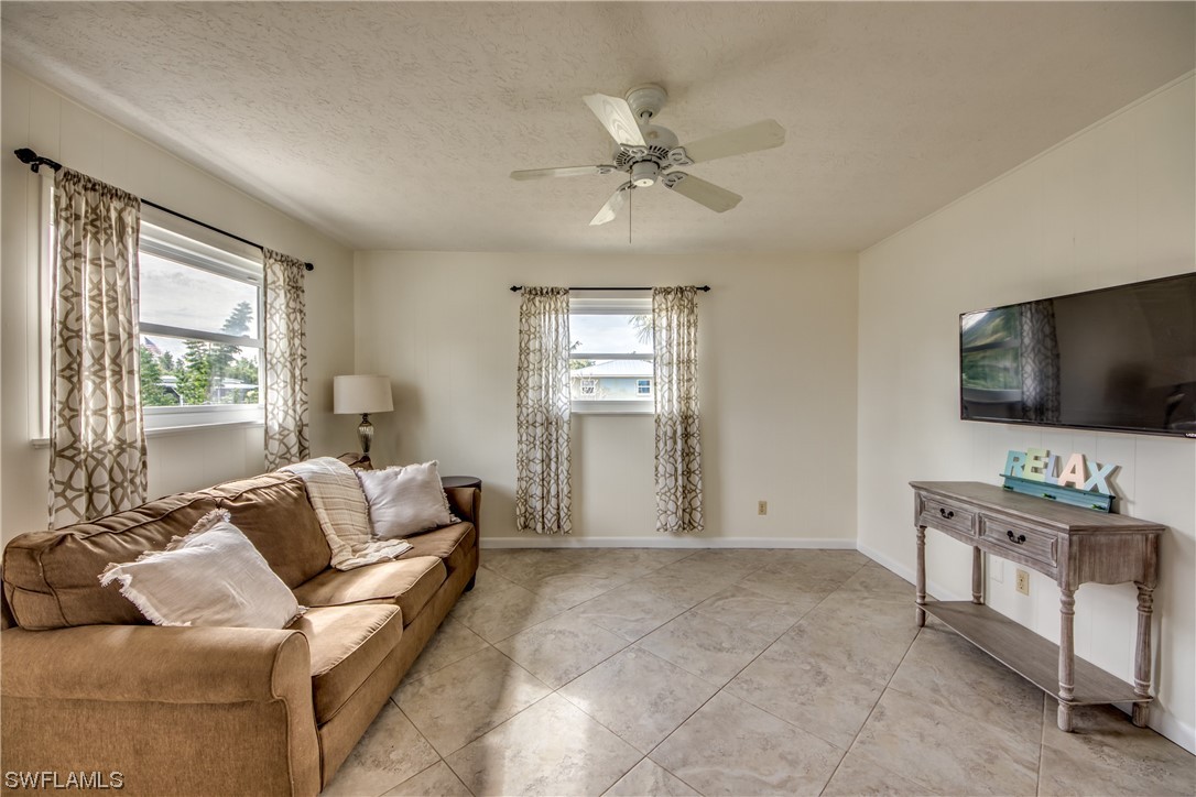 5892 Sailfish Road Bokeelia, FL 33922 - Photo 16 of 32 a living room with furniture and a flat screen tv