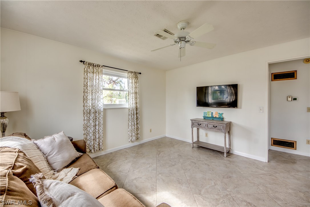 5892 Sailfish Road Bokeelia, FL 33922 - Photo 17 of 32 a living room with furniture and a flat screen tv